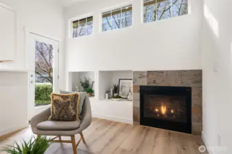 Tall clear story windows, gas fireplace, door to patio and right off kitchen.