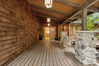 Covered entry with natural wood and stone detail