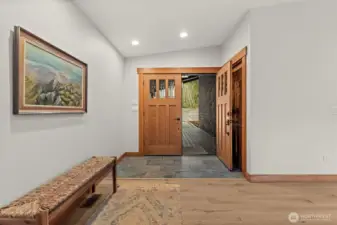 Clean entry with hardwood floors and natural light