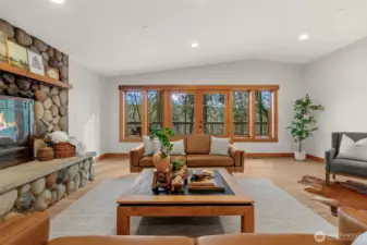 Open living space with large windows and views to the surrounding trees