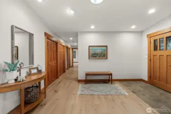 Spacious entry hallway with hardwood floors and built-in storage