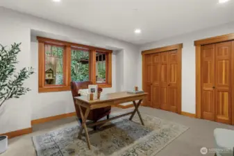 Light-filled bedroom with window views and workspace potential