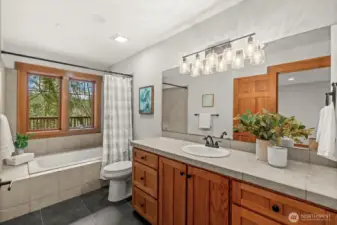 Bathroom with double vanity and full tub/shower combination