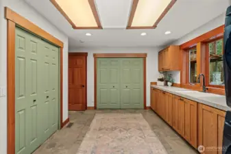 Mudroom and storage area with built-ins and workspace