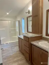 Primary Ensuite with shower, vanity area, & his and her sinks