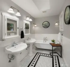Timeless design of primary bath with claw foot tub and separate shower.