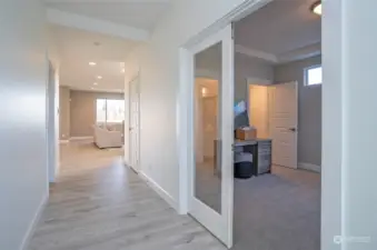 French doors open to a versatile den, office, or 5th bedroom with double closets.