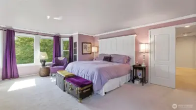 Bright primary bedroom with plenty of windows- filling the space with natural light.
