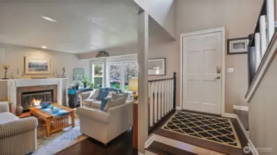 Step into a welcoming open floor plan and rich engineered hardwoods with a smooth flow, offering effortless access to the living room and stairs.