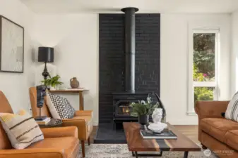 Cozy fireplaces in both living areas flanking kitchen