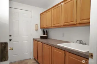 Laundy with lots of storage and sink