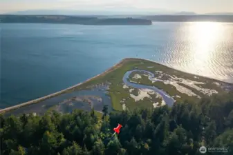 Views of Hood Canal and Olympic Mountains. The property has access to the tideland marsh beach.