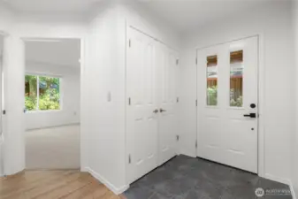 Tiled floor entry, guest closet are near two bedrooms.