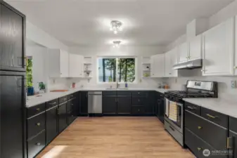 Spacious kitchen with brand new paint and updated quartz counters. Views from new oversize deep sink and faucet.