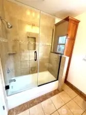 Custom tile work and thick shower door!