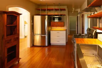 Stainless steel appliances, farm sink, task lighting and hardwood floors make this a sleek space to work and enjoy.