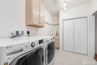 Utility room with sink and more storage...Make sure to check out the special feature in this closet!
