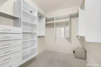 Custom closet organizers and a secret door to the laundry closet clothing basket for easy transfer!