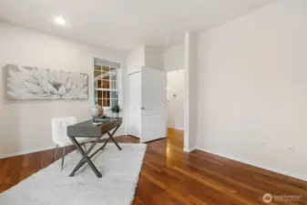 The third bedroom with lovely wood floors and storage under the bench and closet!