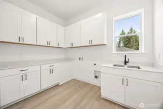 Laundry Room  Photos are of another home in the community- finishes will vary.