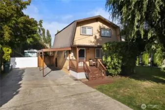 Charming curb appeal with a country feel—level lot with fruit trees and fully fenced yard.