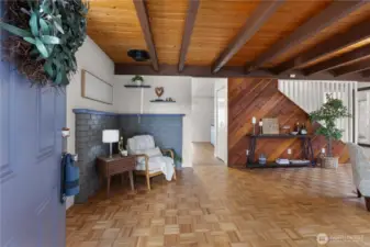 Spacious entryway with wood floors leads into the heart of the home.