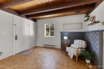 Cozy living area with warm wood ceilings and abundant natural light.