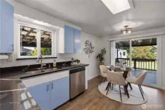 Beautifully designed kitchen with rich blue cabinetry, quartz countertops, and stainless steel appliances—where function meets style.