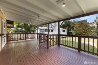 Covered back deck offers space for outdoor dining and lounging.