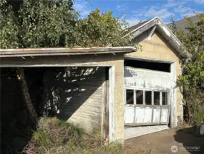 Closer view of the tree growing out of the garage