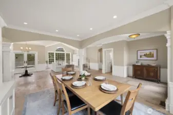 Formal dining area with open living room, less formal dining area off kitchen and half-bath.