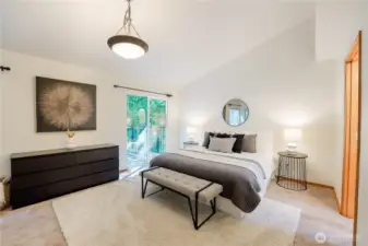 Giant primary suite with deck, closets, vaulted ceilings, and en suite with skylight.