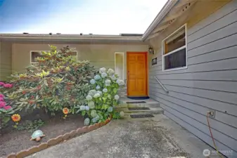 Main entrance from huge, paved driveway.