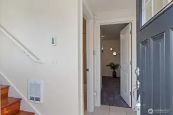 Just past the front door is a coat closet and garage entrance