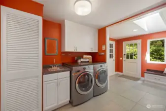 Laundry Room off the garage is perfect for dropping off muddy soccer and sports gear!  Out in the garden? Half bath and sink means you don't have to remove your garden shoes!