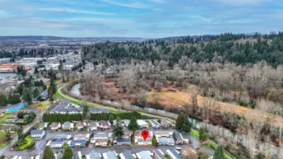 Aerial view pinpointing this quaint home nestled in the heart of Kent close to major freeways, amenities, and the Green River.