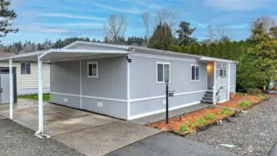 Convenient covered carport with paved walkway to your front door.