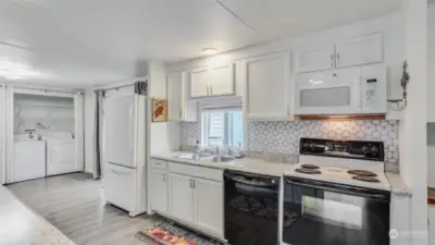 Modern laminate flooring runs throughout the main living spaces in this home offering seamless transitions from room to room.