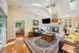 Main Home - Living room with vaulted ceilings, see through fireplace.