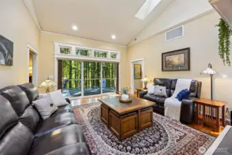 Main Home - Living room with large open windows leading to the deck with territorial views of the backwoods and Deschutes River.