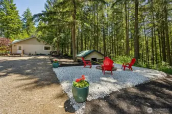 Fire pit area. Pump/well house pictured to the right just below grade.