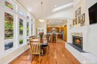 Main Home - Dining area with fireplace leading to kitchen.
