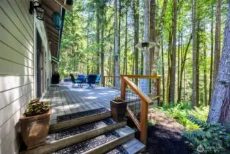 Main Home - Deck stretches along the back side of home with access off of the primary bedroom and the living room.