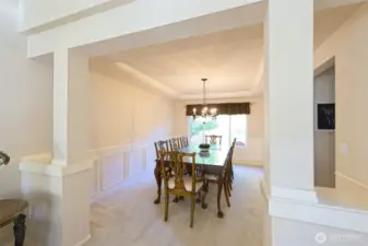 Formal dining room with elegant wainscoting.
