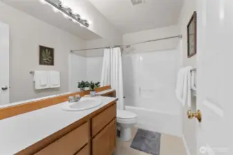 Crisp, clean, and move-in ready—this full upstairs bathroom features a large mirror, updated lighting, and a sparkling tub/shower combo, ideal for busy mornings or winding down after a long day.