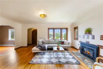 Cozy formal living room with original lead glass windows. gas fireplace.