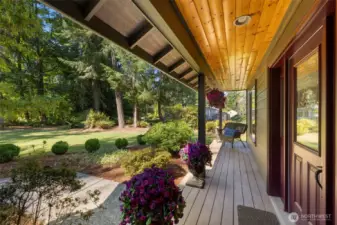 Classic craftsman-style porch with plenty of room for chairs or seasonal décor. A great spot to enjoy the peaceful setting and views toward Lake Bosworth.