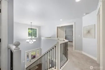 Open to the foyer below with stylish black-accented stair railings.