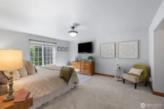 Spacious and serene primary suite with plenty of natural light, ensuite bath, and room for a king-size bed and additional furniture.