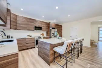 Spacious kitchen with large island, stainless steel appliances, & walk-in pantry